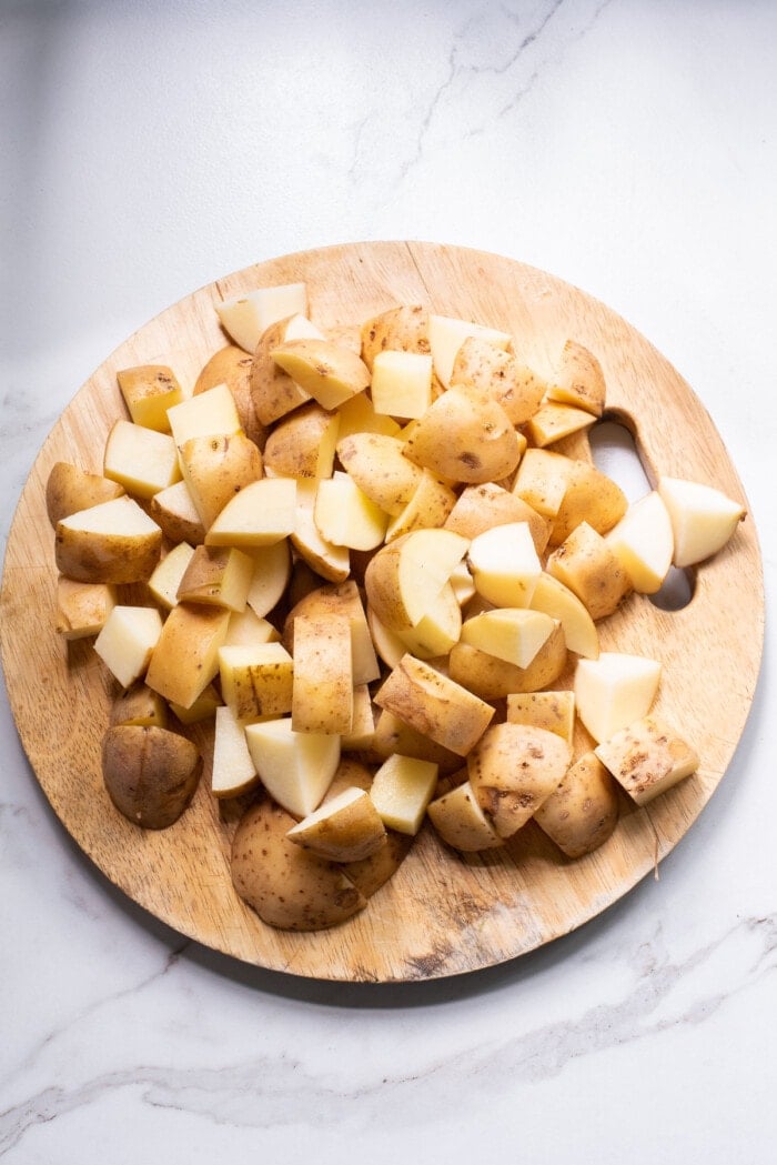 potatoes cut into chunk on cutting board