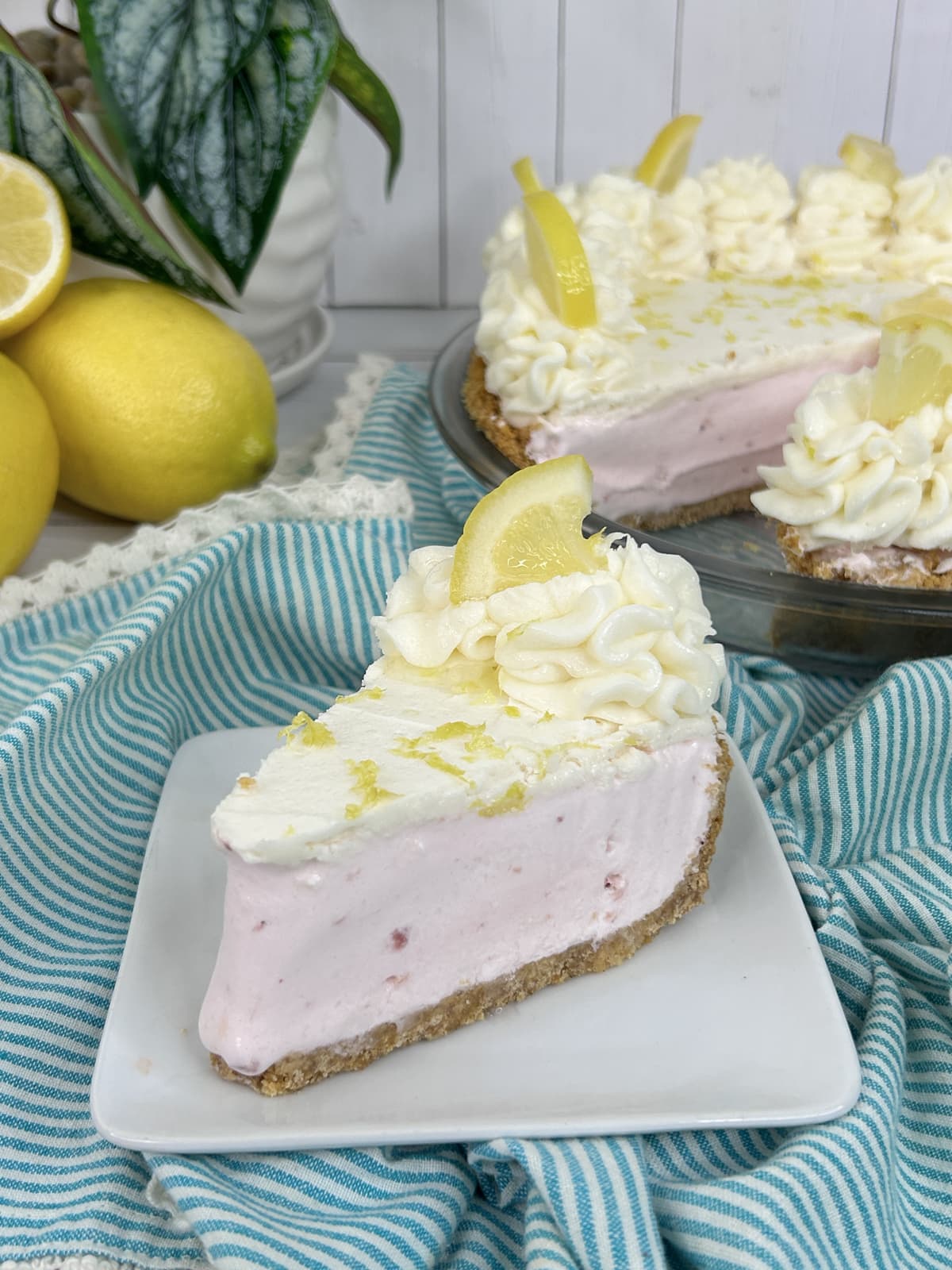 pink lemonade pie with lemon zest and cut lemon on top