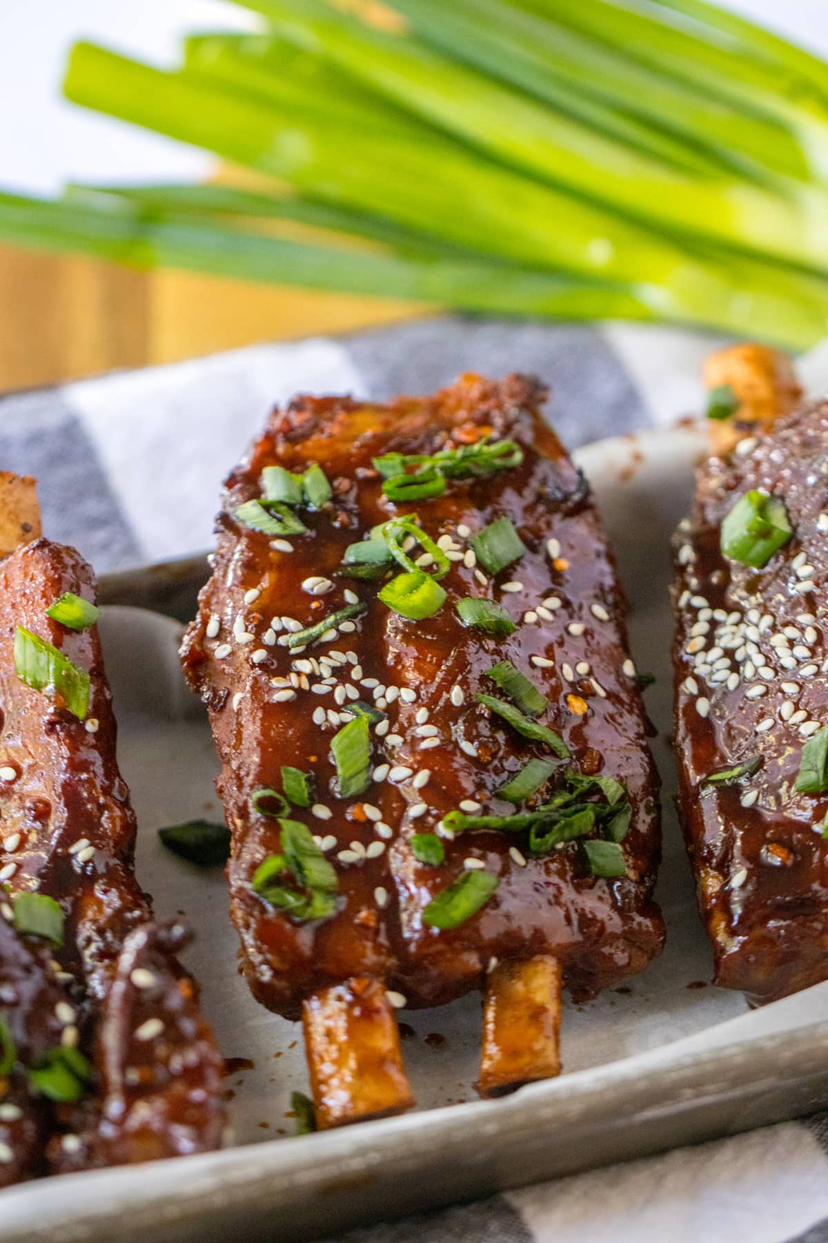 chinese spare ribs on platter with sesame seeds and green onions