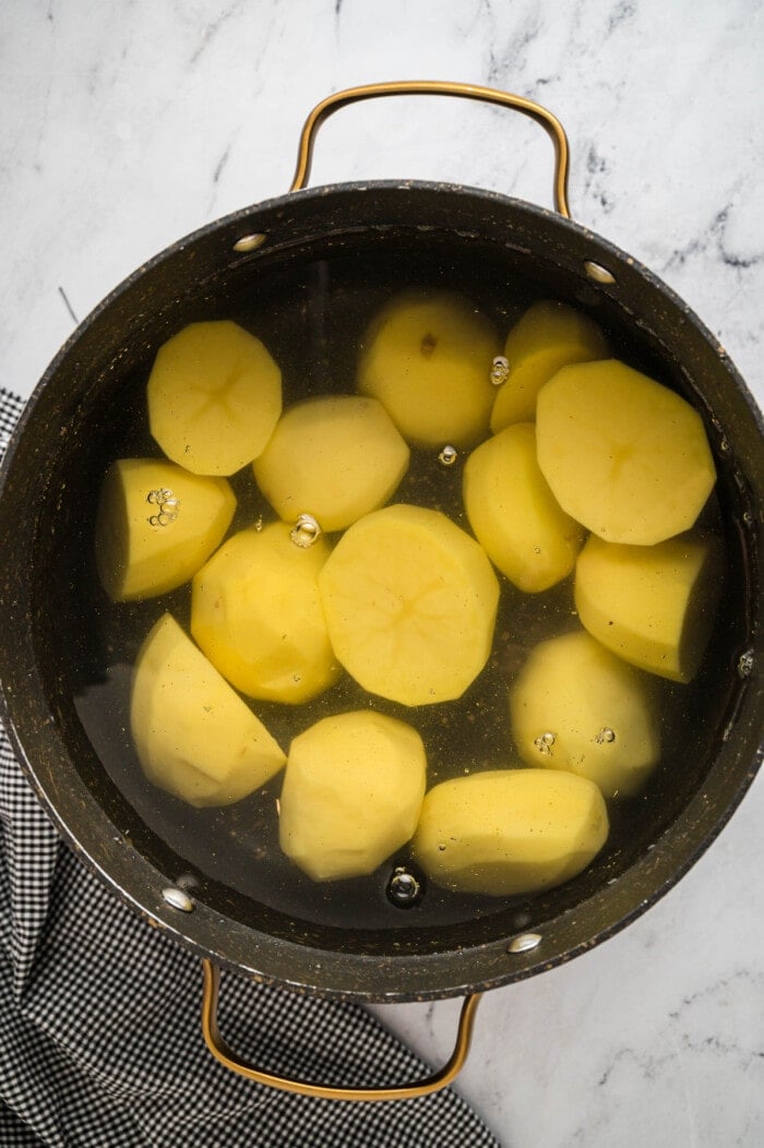 Yellow potatoes in a pot of water