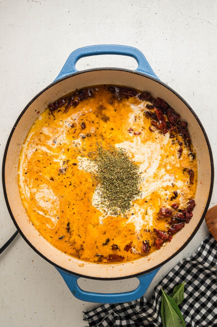 Butter, heavy cream, sundried tomatoes, and seasonings in a skillet