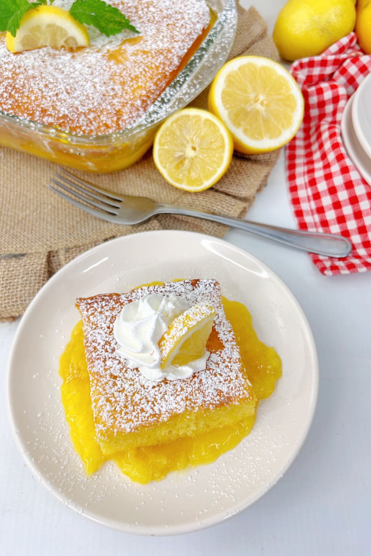 warm lemon pudding cake on a white plate