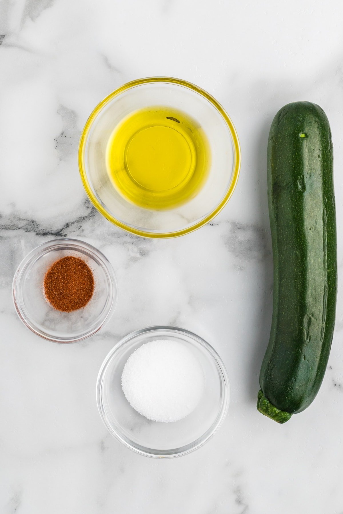 ingredients - paprika, salt, oil and zucchini