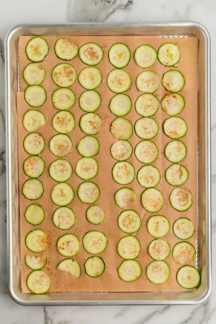 zucchini chips on baking sheet with spices