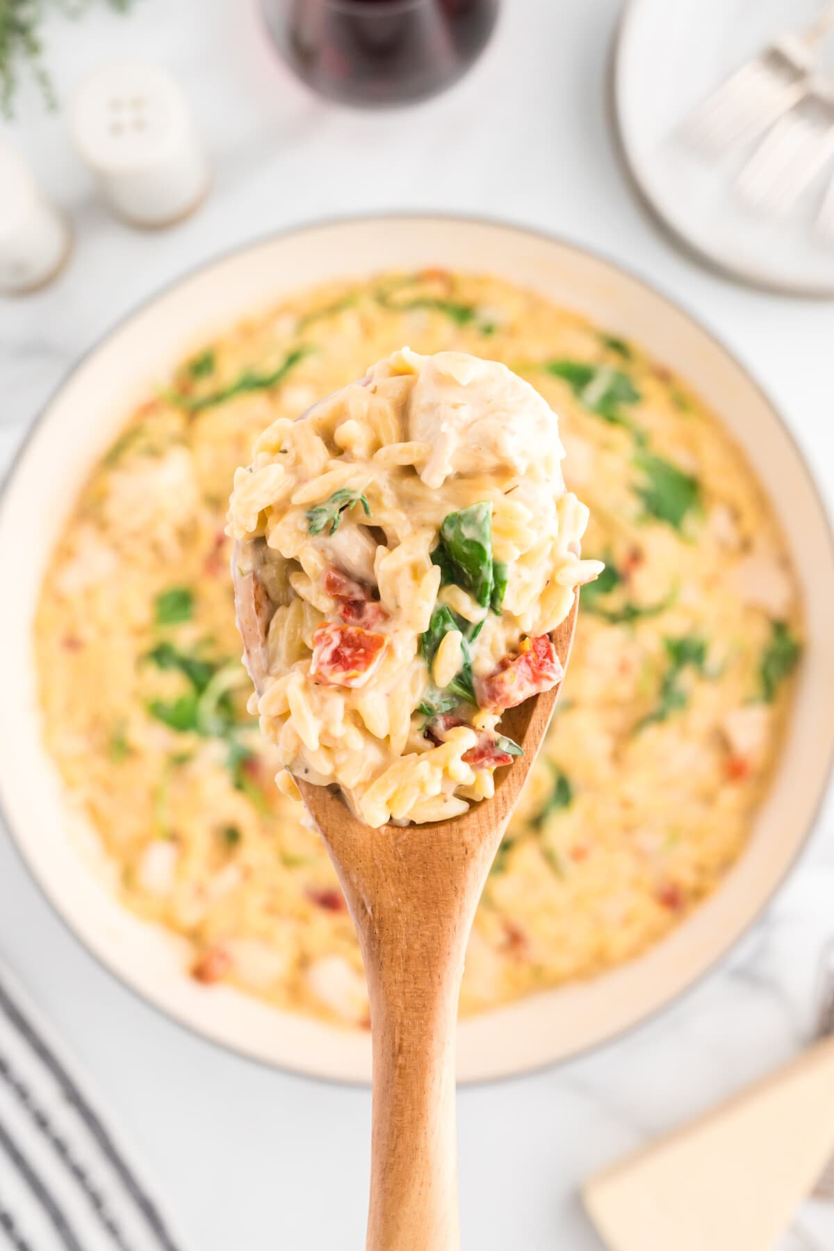 Creamy Chicken Orzo with a wooden spoon