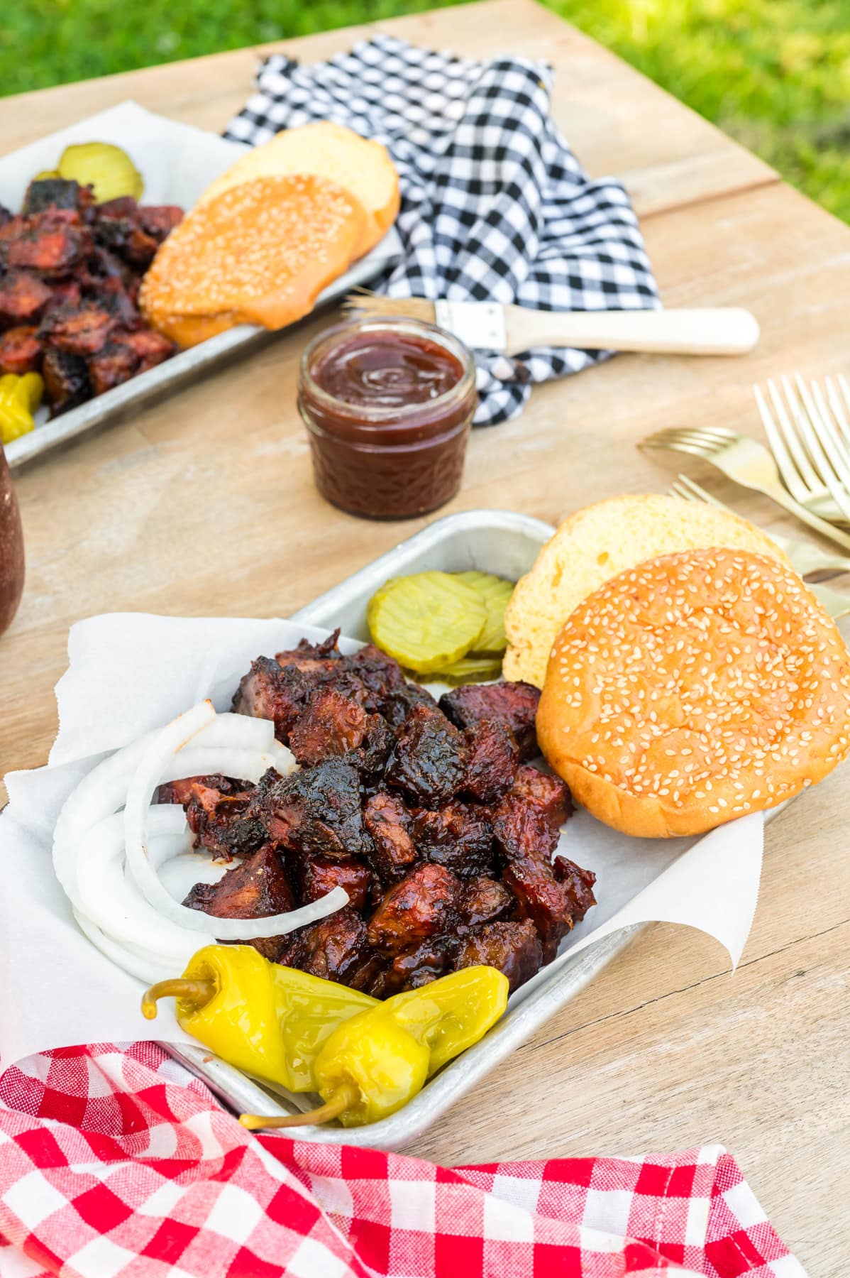 Chuck roast burnt ends on a tray with bread and pickles