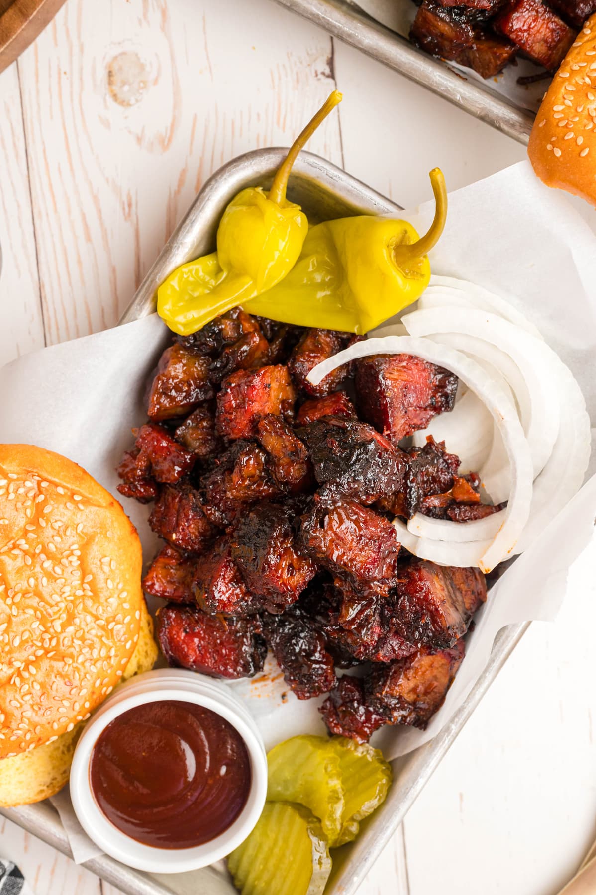 Overhead view of poor man's burnt ends with a burger bun