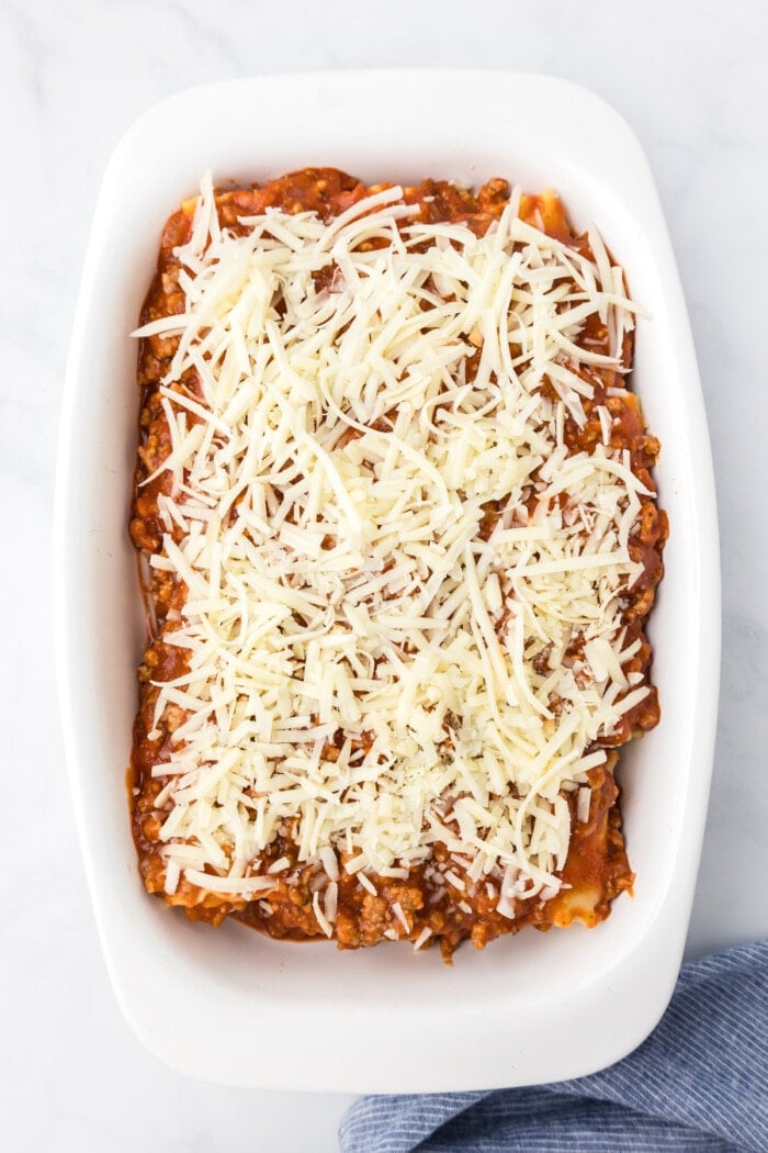 shredded cheese on top of lasagna roll ups