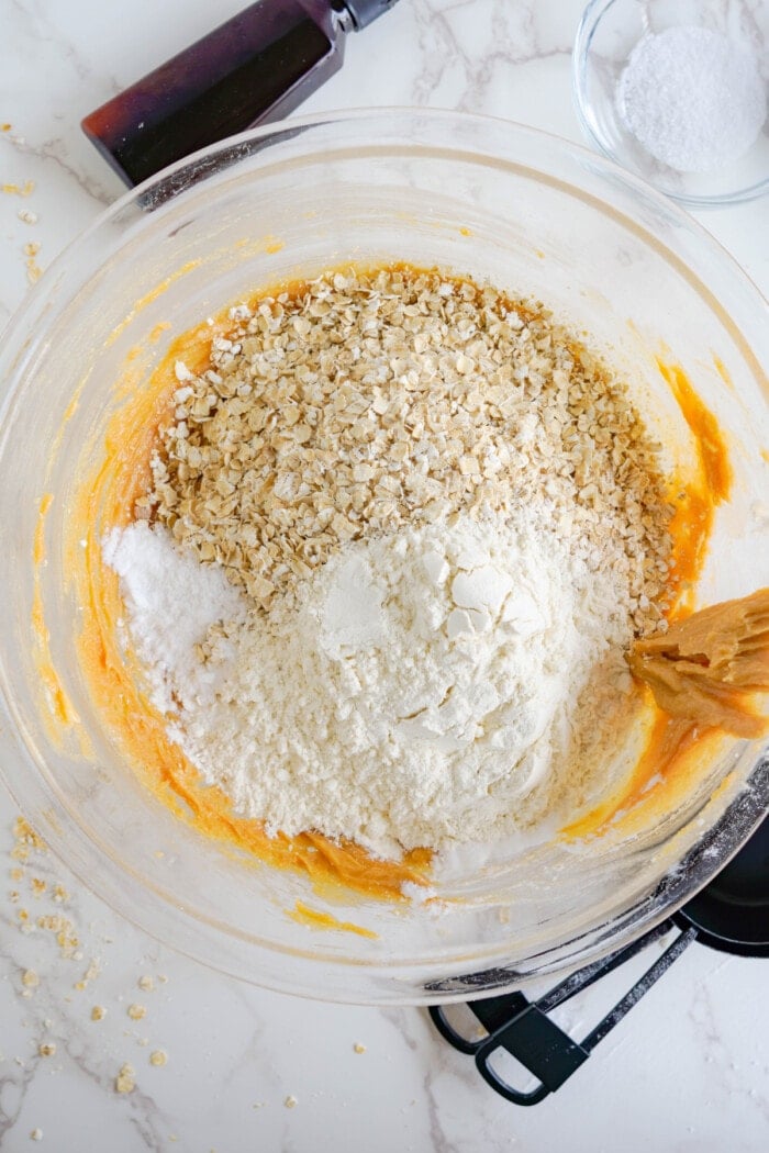 dry ingredients and rolled oats in bowl