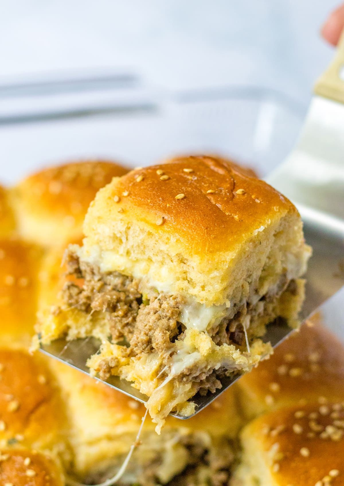 spatula serving philly cheesesteak sliders