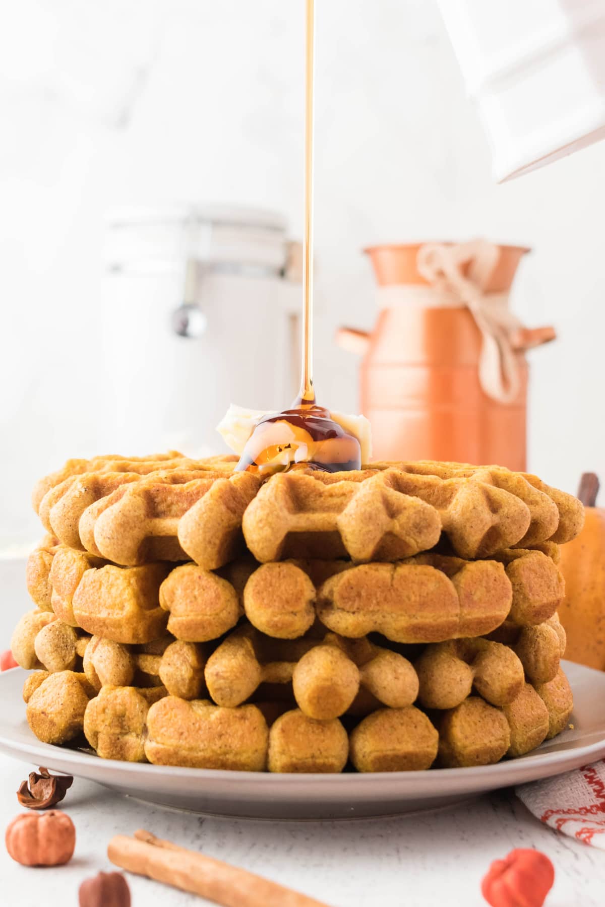 stack of pumpkin waffles with syrup
