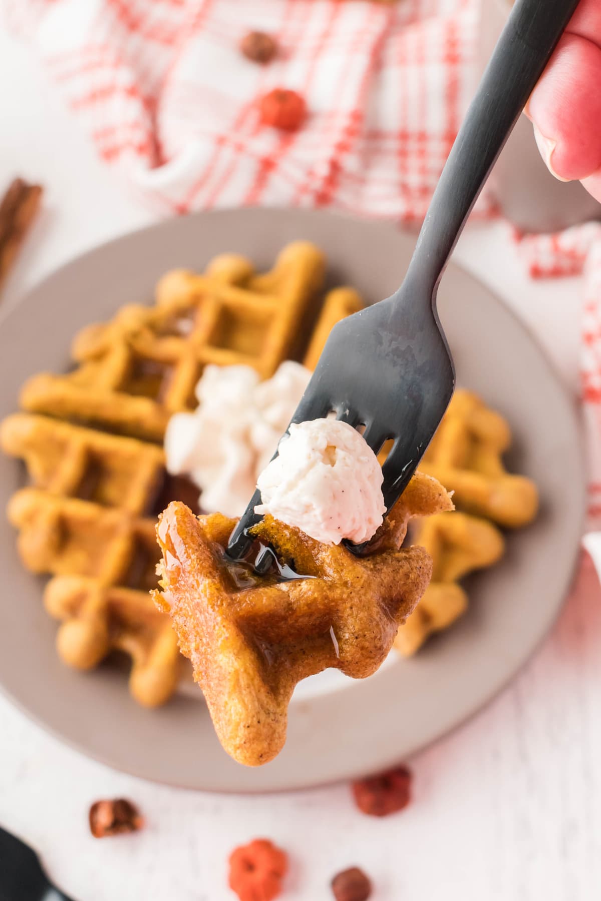 fork with bite of pumpkin waffle