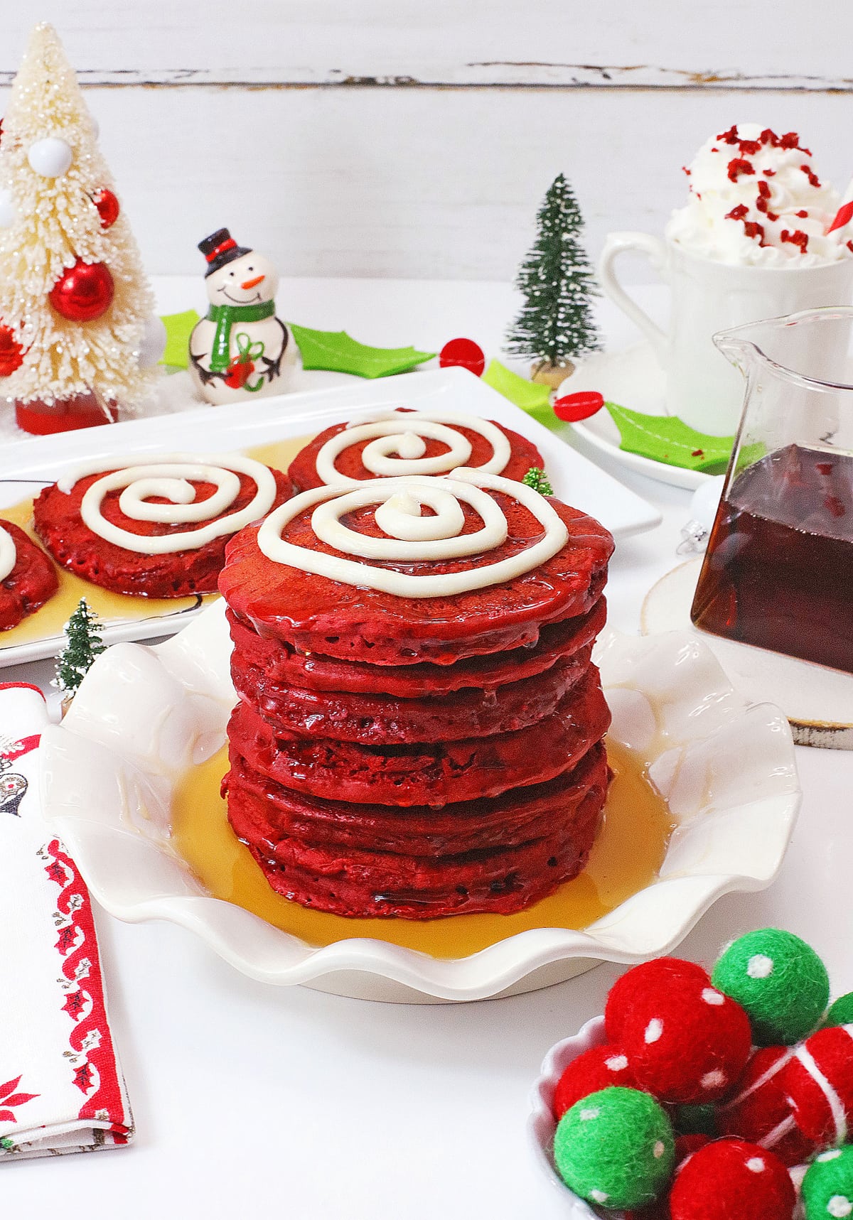 red velvet pancakes stacked on white plate