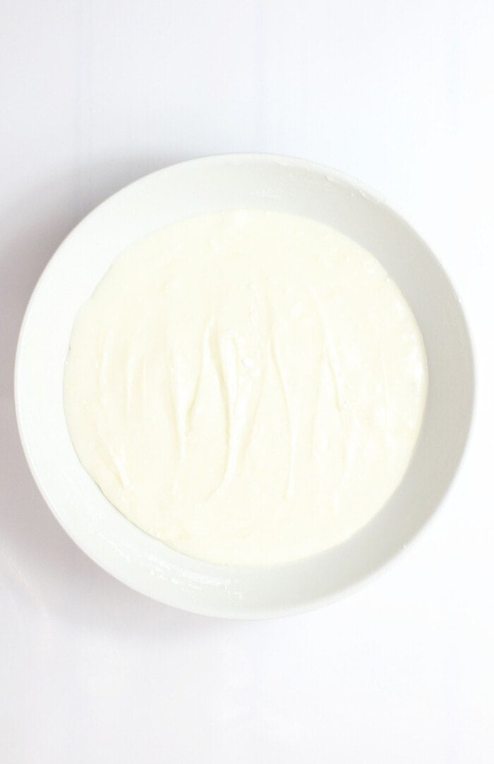 cream cheese frosting in white bowl