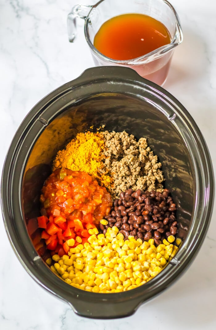 ground beef, beans, corn and spices in crock pot