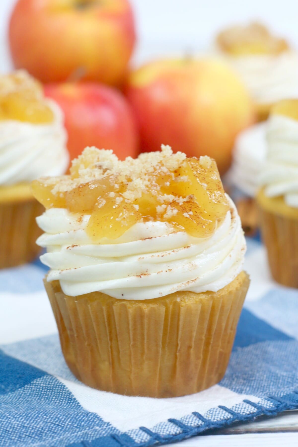 apple pie cupcakes sitting on a blue and white checked napkin