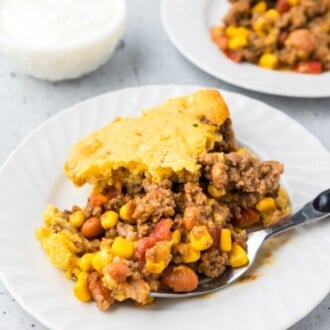 cowboy cornbread casserole on white plate with fork