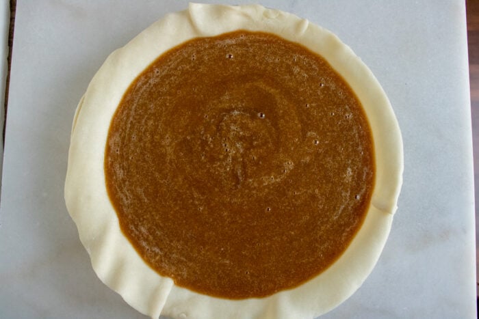 pumpkin pie filling in a pie crust