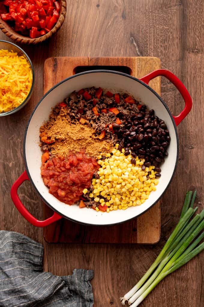Beans, salsa, and corn added to the ground beef