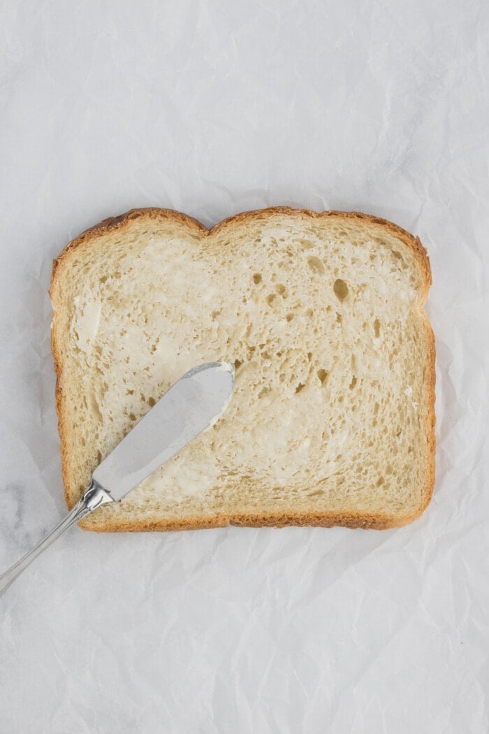 slice of bread with butter spread on it