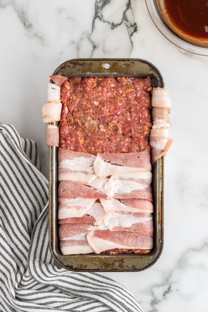 meatloaf in loaf pan with bacon