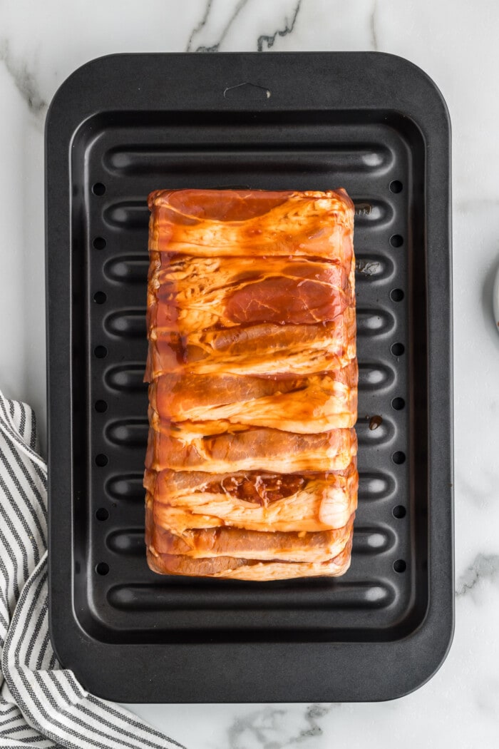 bacon wrapped meatloaf on baking pan