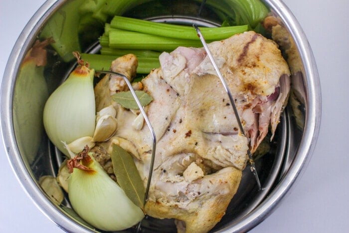 chicken bones, celery, onion, garlic and seasoning in instant pot