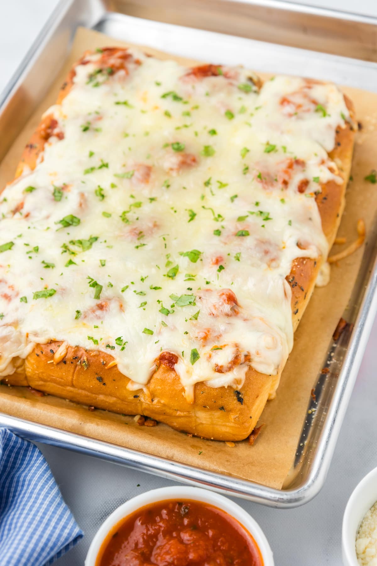 meatball sliders baked with parsley for garnish on top