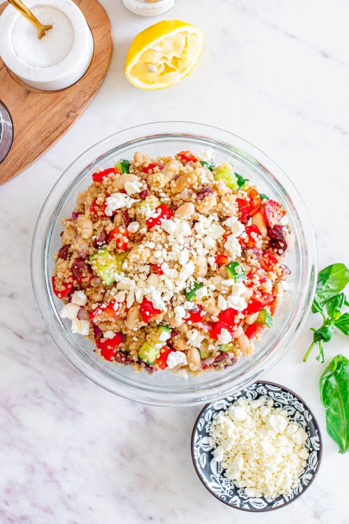 Mediterranean quinoa salad in bowl with feta cheese on top