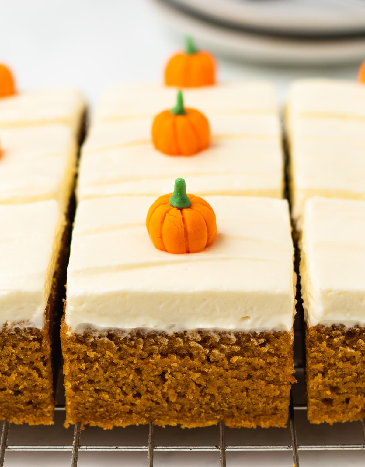 pieces of pumpkin sheet cake on wire rack