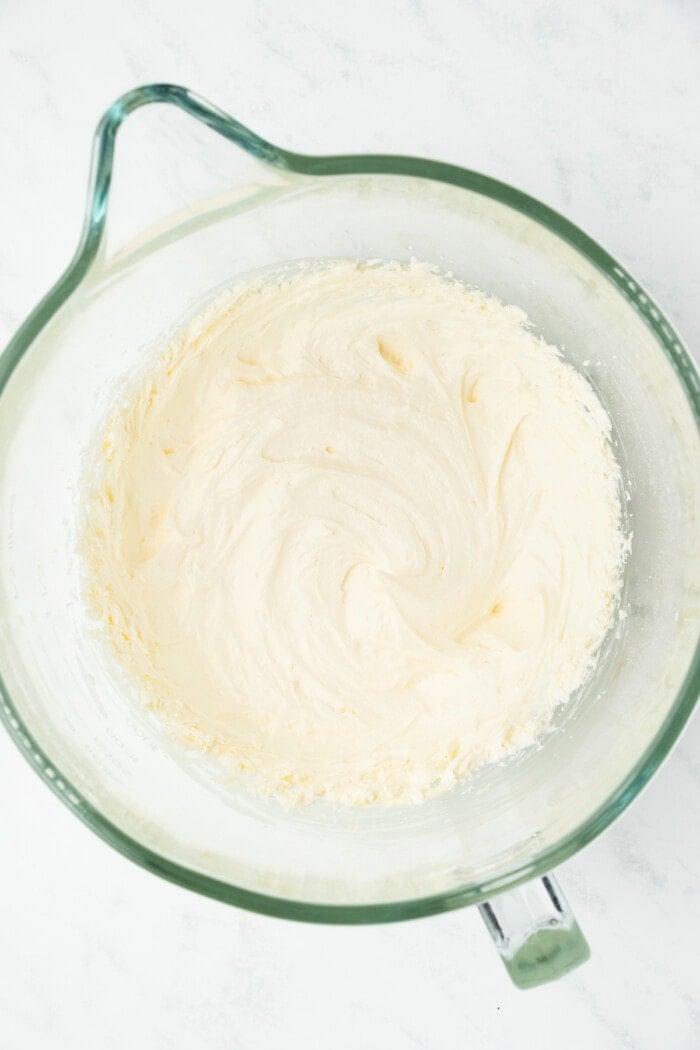 cream cheese frosting in glass measuring bowl