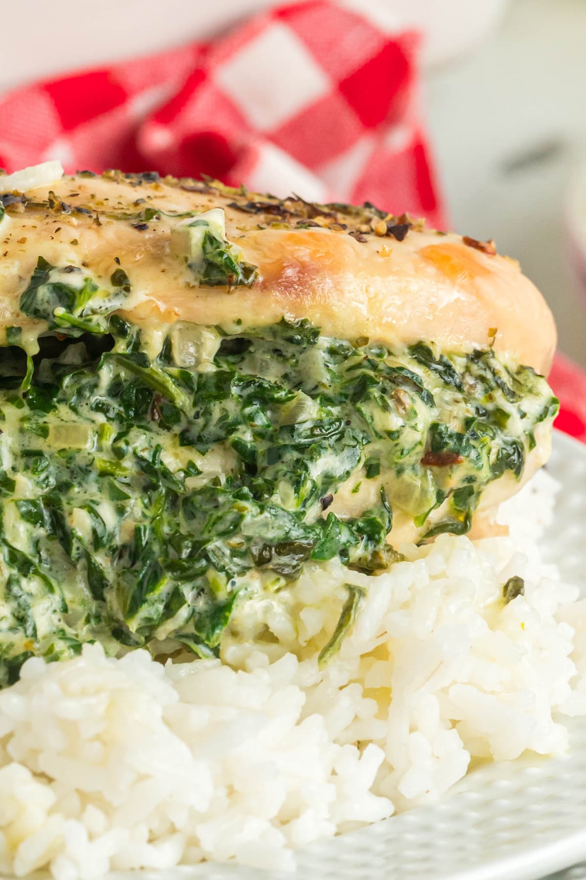 Close up of a stuffed chicken breast with spinach on rice