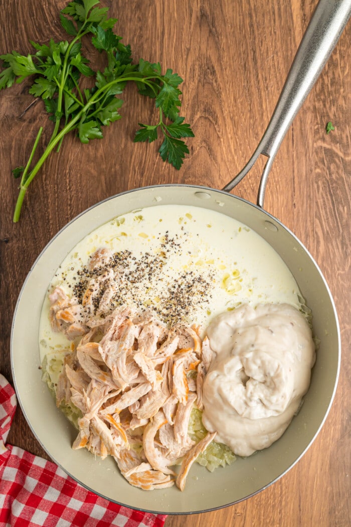 Turkey, cream of mushroom sour, cream, and seasonings in a pan