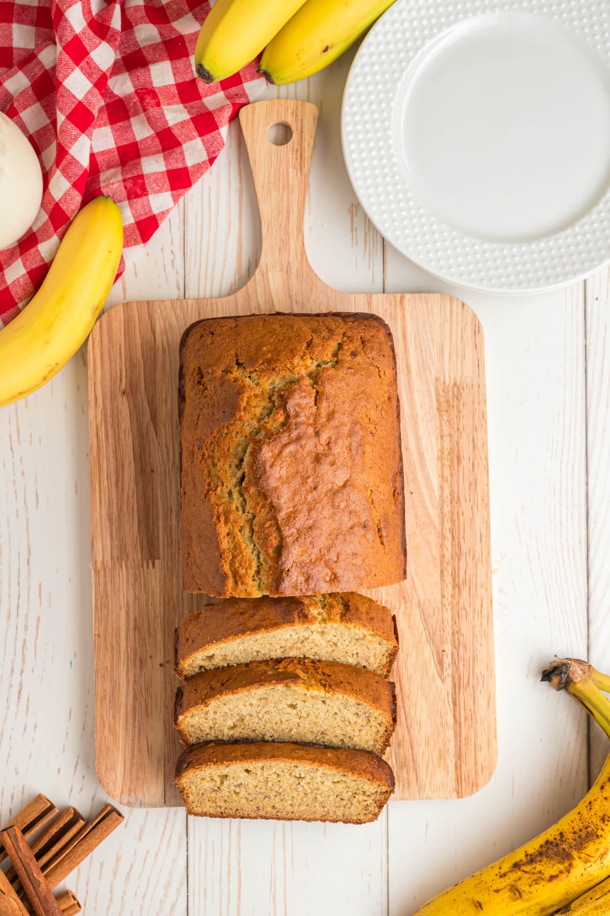 Overhead view of a loaf of banana bread on a cutting board