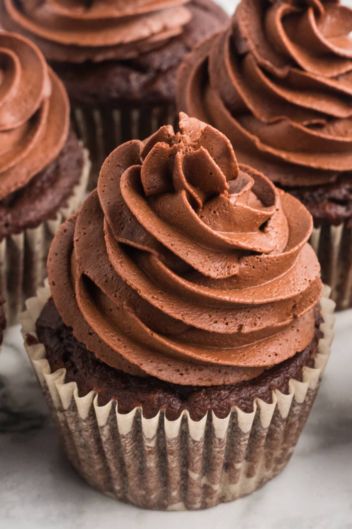 A chocolate cupcake topped with chocolate ganache