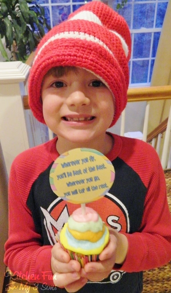 boy holding Dr Seuss cupcake