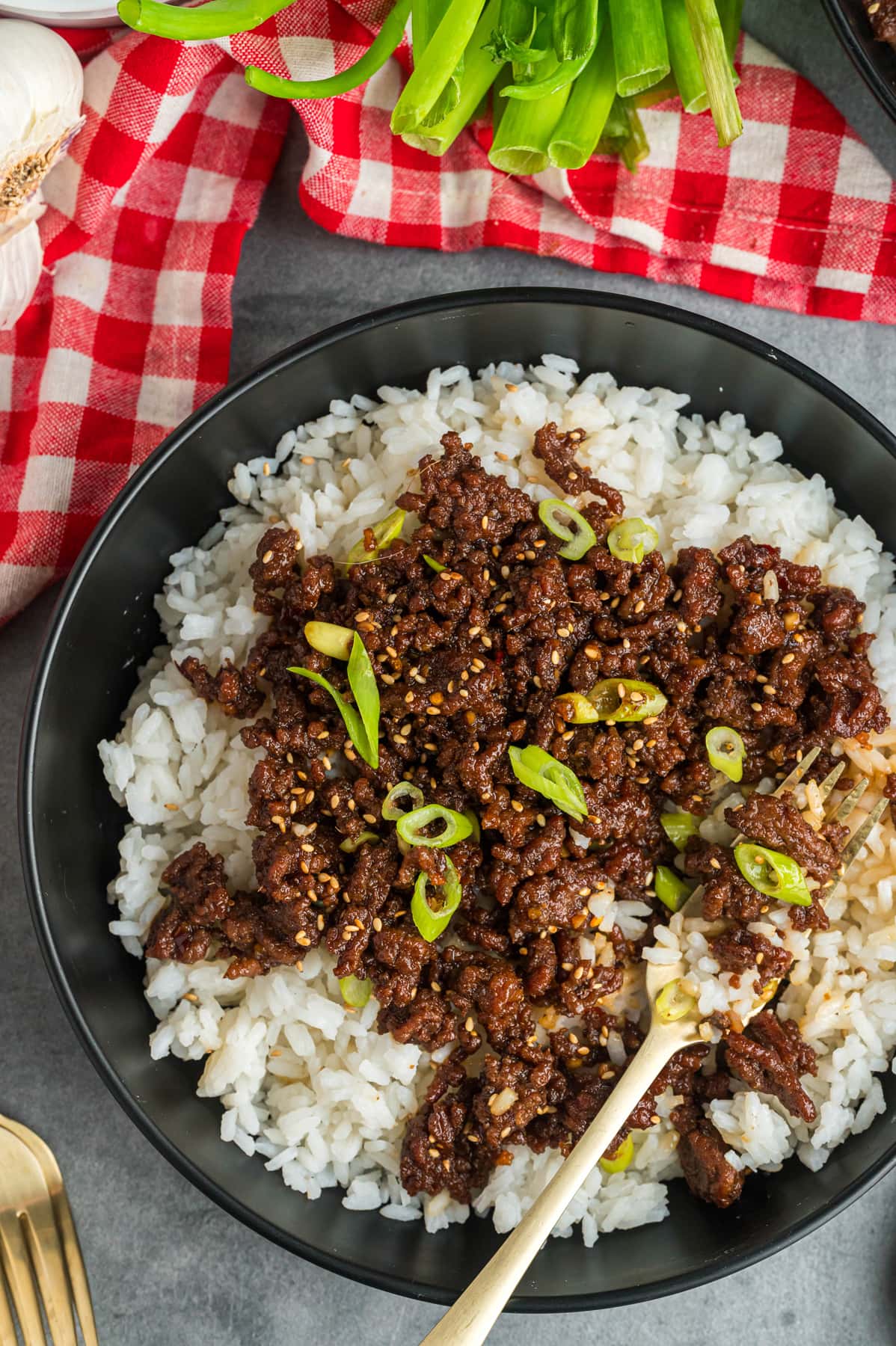 Korean beef over rice on a black plate