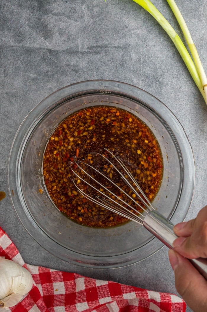 A whisk in a bowl of Korean beef marinade