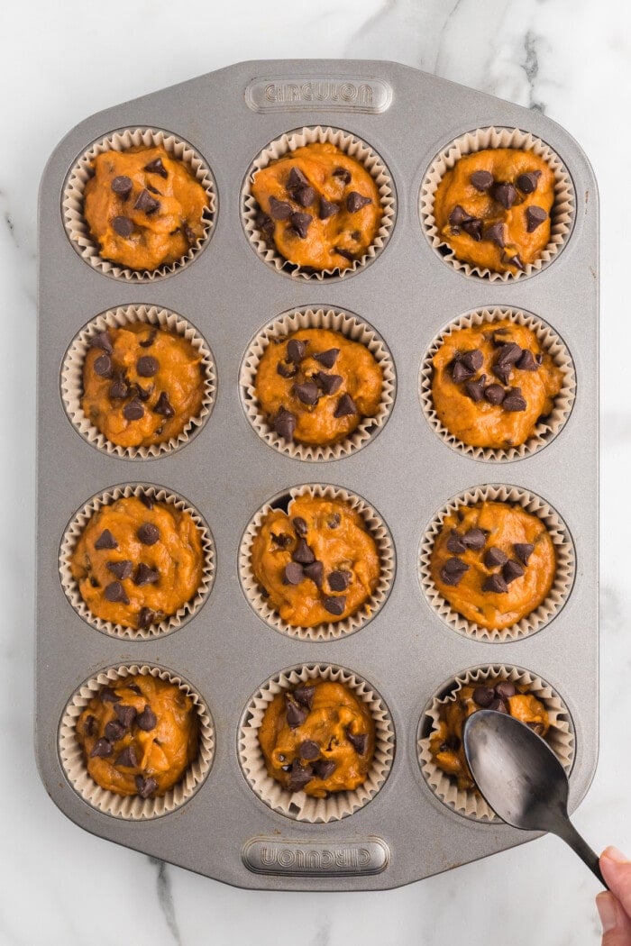 Chocolate chip pumpkin muffin batter in a cupcake pan