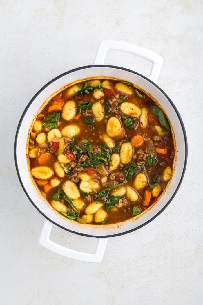 spinach in pot with sausage gnocchi soup
