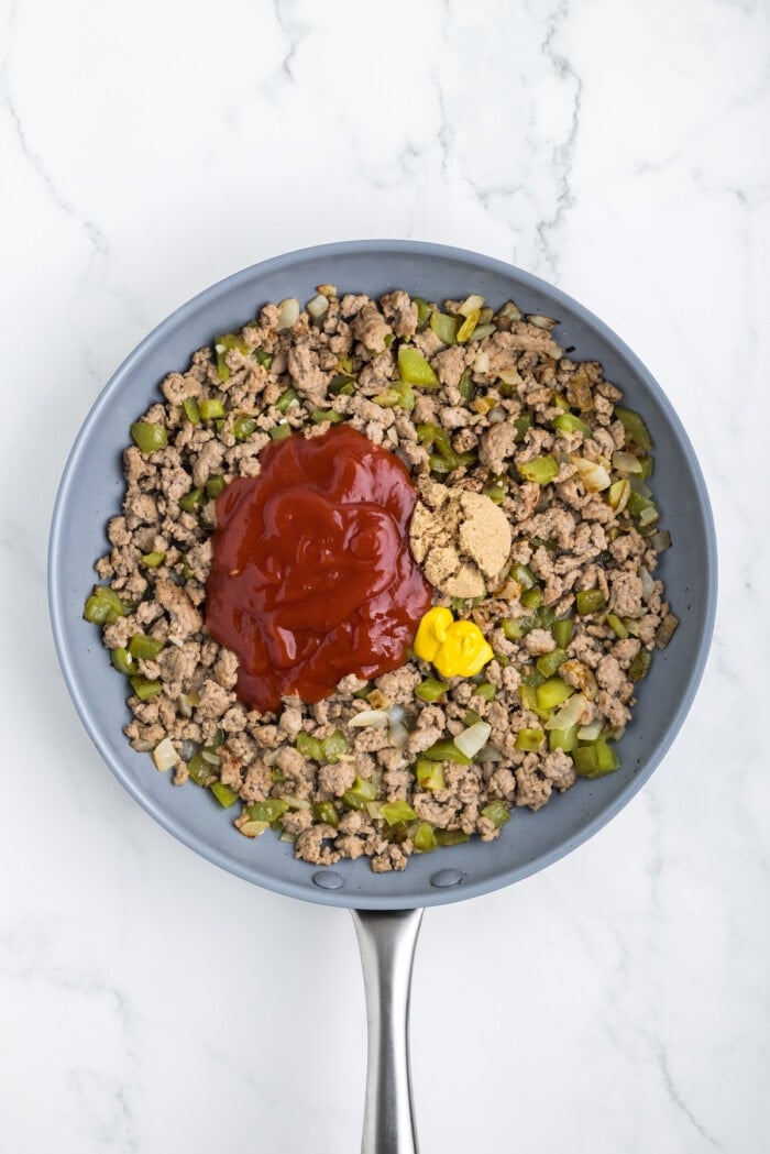 ketchup, mustard and brown sugar in skillet with cooked ground turkey