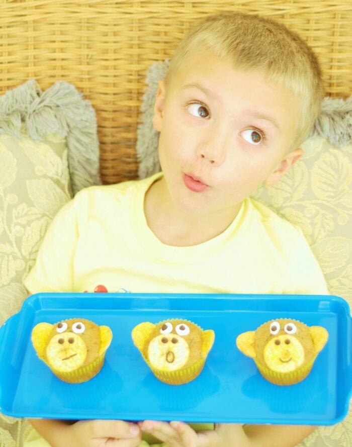 Boy holding a tray of Banana Nut Monkey Muffins 