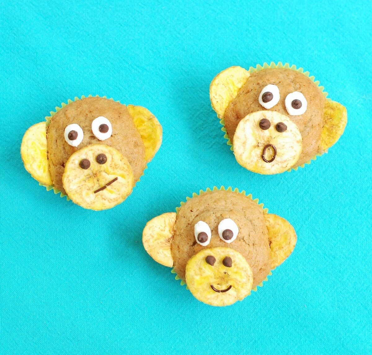 banana nut muffins that look like monkeys on a blue cloth