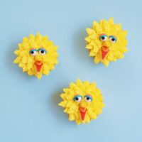 3 yellow big bird cupcakes on a blue background