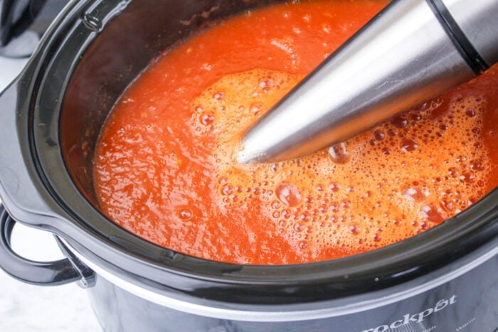 immersion blender mixing tomatoes