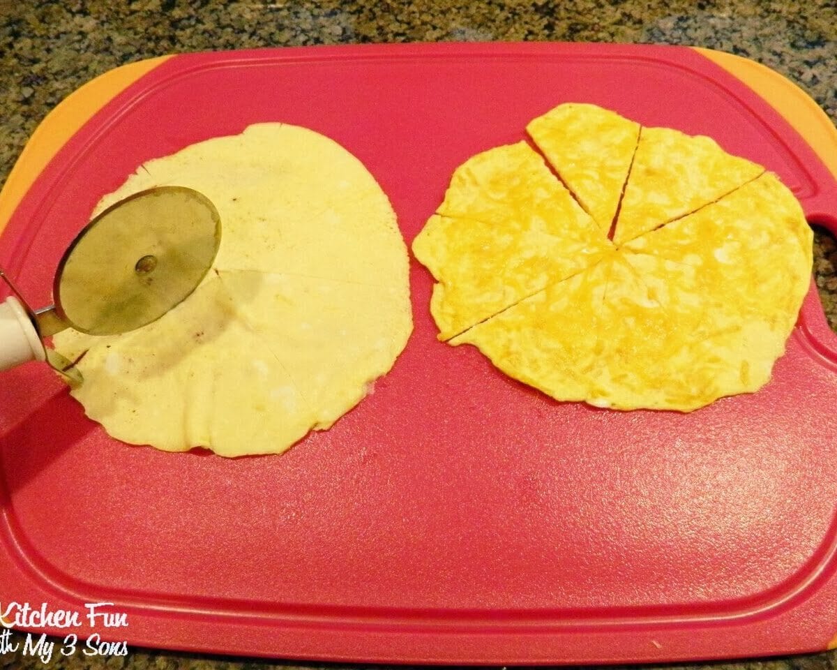 cutting a cooked egg on a red cutting board