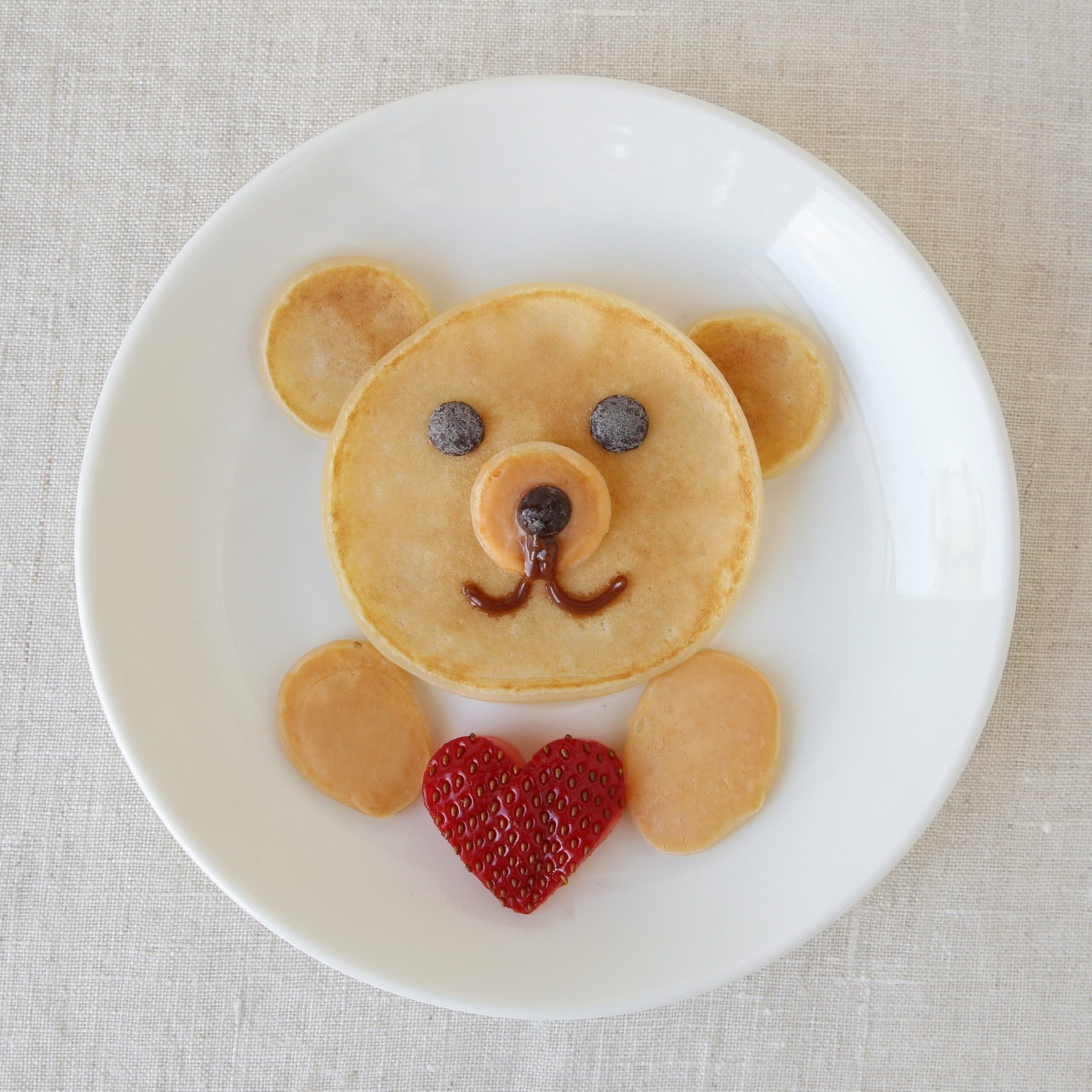 Teddy bear face pancakes on a plate