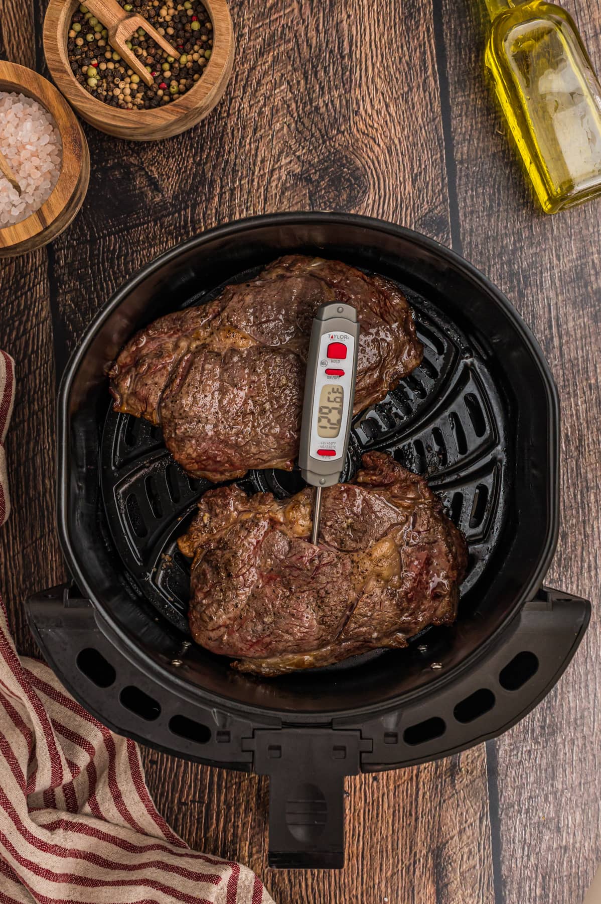 A thermometer in a ribeye steak in the air fryer