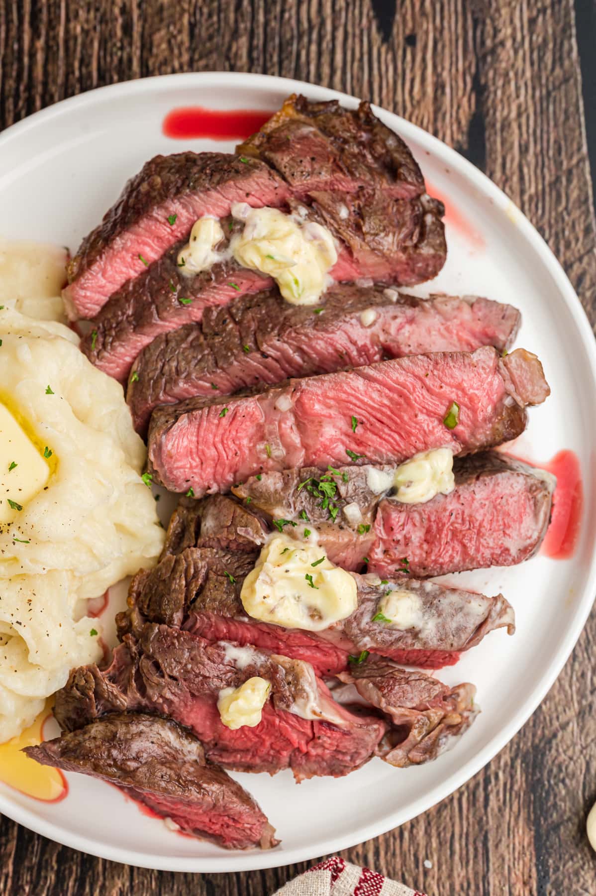 Air fryer ribeye steak sliced on a plate with mashed potatoes