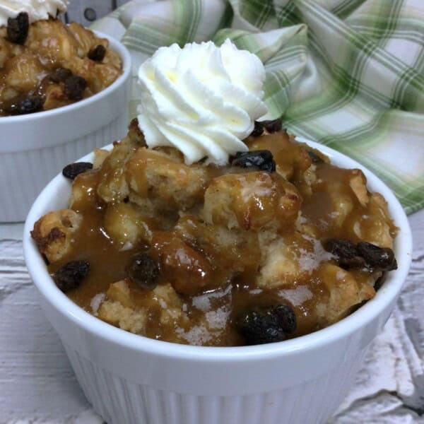 Irish Whiskey Bread Pudding with whipped cream on top in a ramekin
